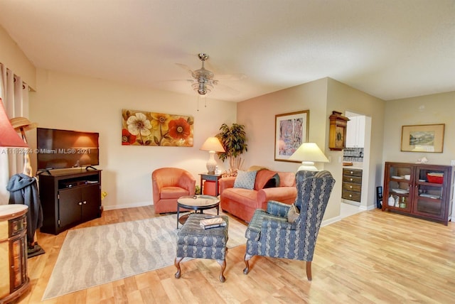 living room with ceiling fan and light wood-type flooring