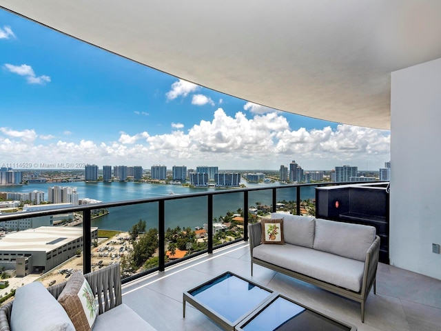 balcony featuring outdoor lounge area and a water view