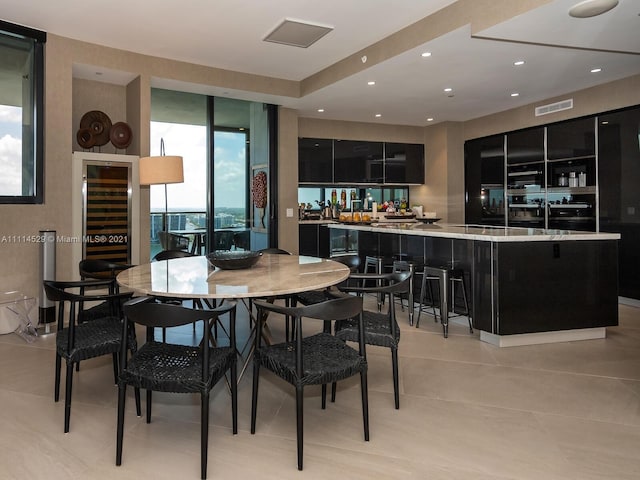 dining space with bar and light tile floors