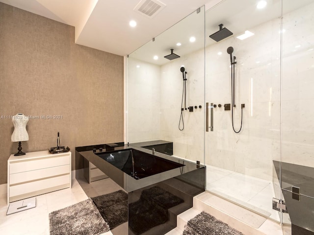 bathroom featuring shower with separate bathtub and tile flooring