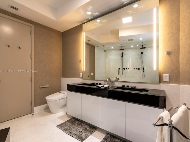 bathroom with toilet, tile floors, large vanity, and a tray ceiling