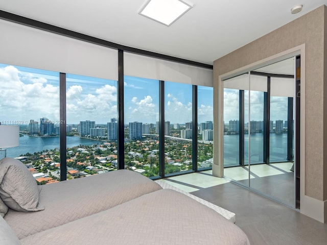 bedroom with a water view, a closet, and multiple windows