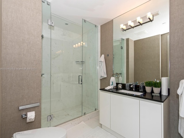 bathroom featuring a chandelier, large vanity, and an enclosed shower