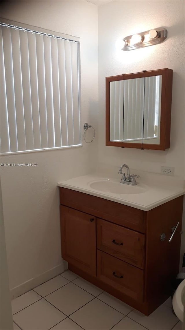 bathroom with tile patterned flooring and vanity