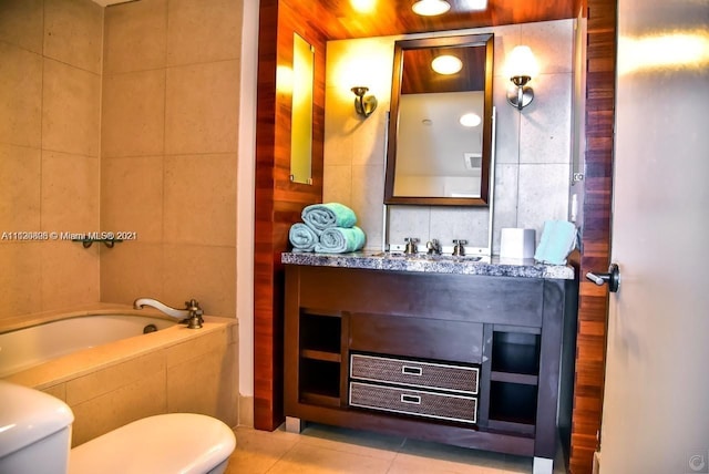 bathroom featuring vanity, tile walls, tile flooring, toilet, and tiled bath