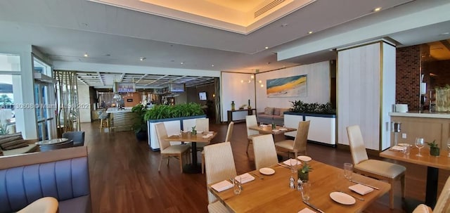 interior space featuring brick wall and hardwood / wood-style flooring