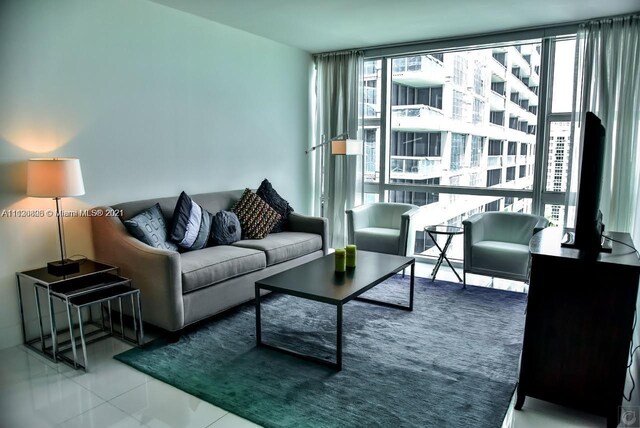 living room with floor to ceiling windows and tile floors