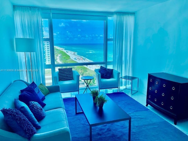 living room with floor to ceiling windows and a water view