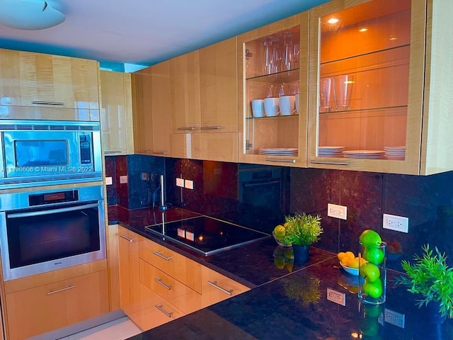 kitchen featuring appliances with stainless steel finishes and tasteful backsplash