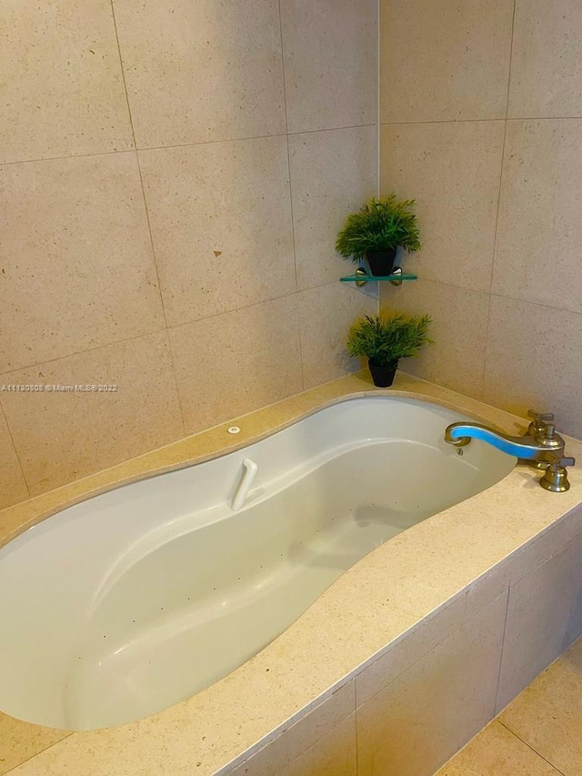 bathroom with tiled tub