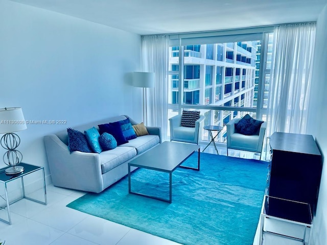 tiled living room featuring a wall of windows