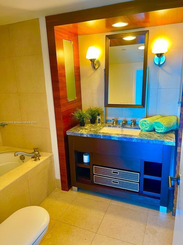 bathroom with tile walls, tile floors, toilet, and tiled tub