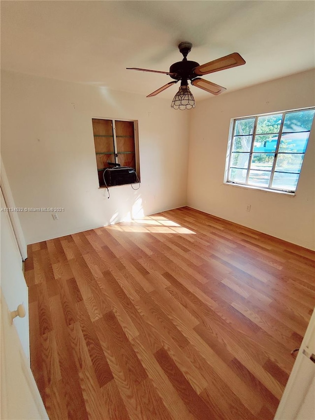 unfurnished room with hardwood / wood-style floors and ceiling fan