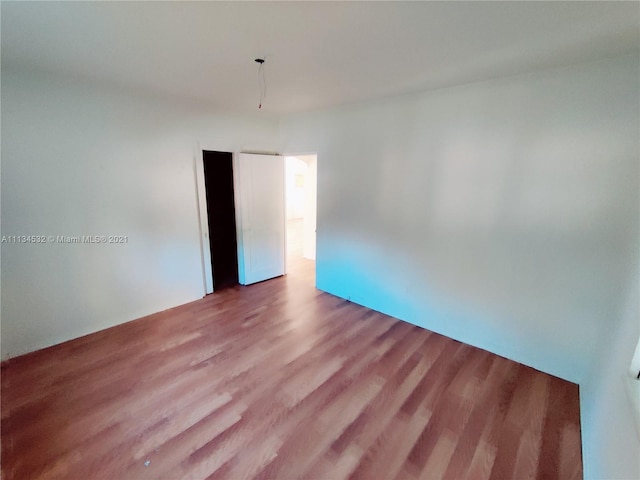 spare room featuring dark wood-type flooring