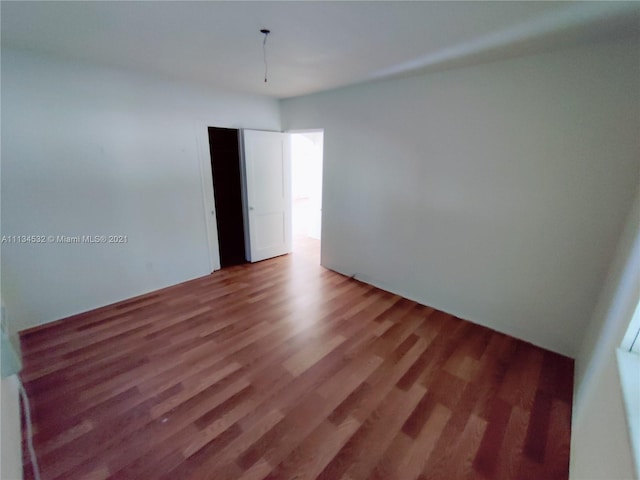 unfurnished room featuring dark hardwood / wood-style floors