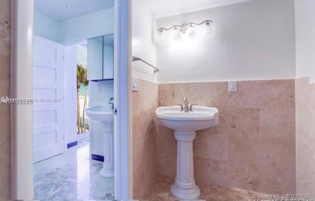 bathroom featuring tile walls and tile flooring