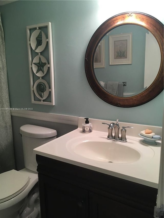 bathroom featuring large vanity and toilet