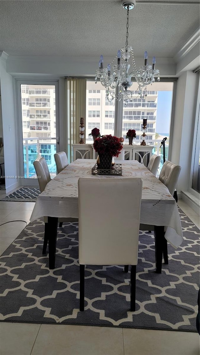 dining room featuring tile flooring, a textured ceiling, and an inviting chandelier