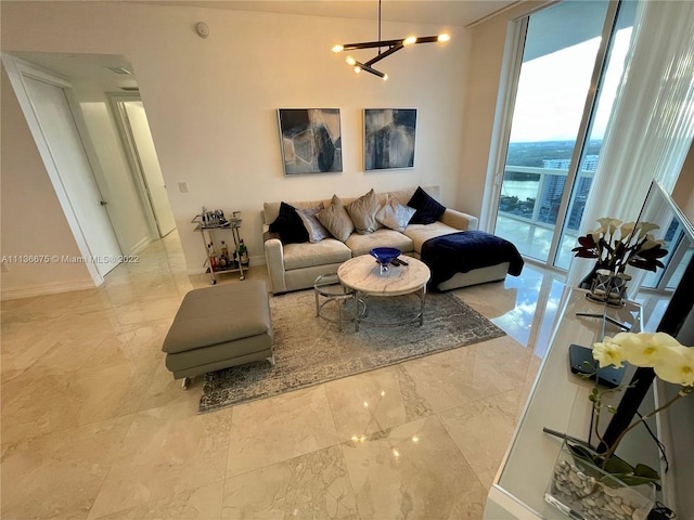 living room featuring an inviting chandelier, expansive windows, and light tile floors