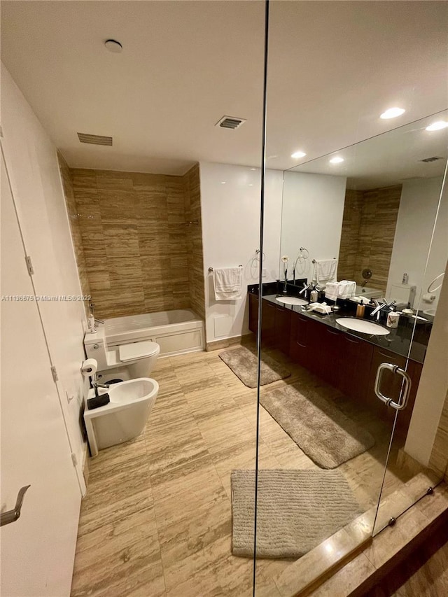 bathroom featuring double sink, a bidet, tile flooring, oversized vanity, and shower / bath combination with glass door