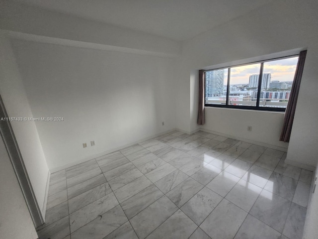 unfurnished room featuring light tile floors