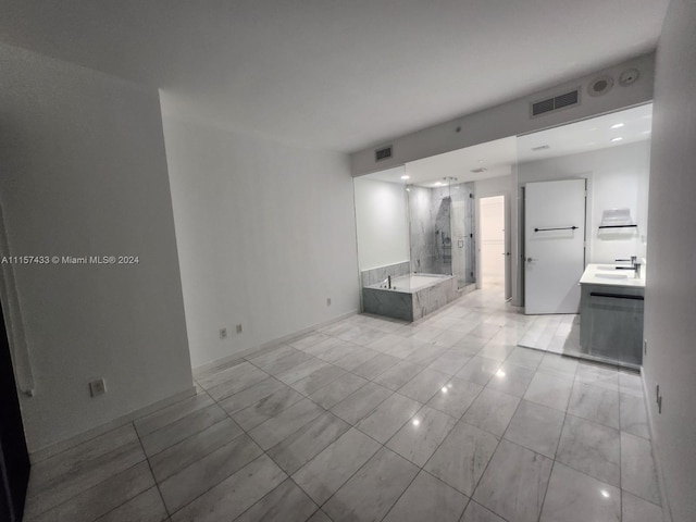 interior space with light tile floors and sink