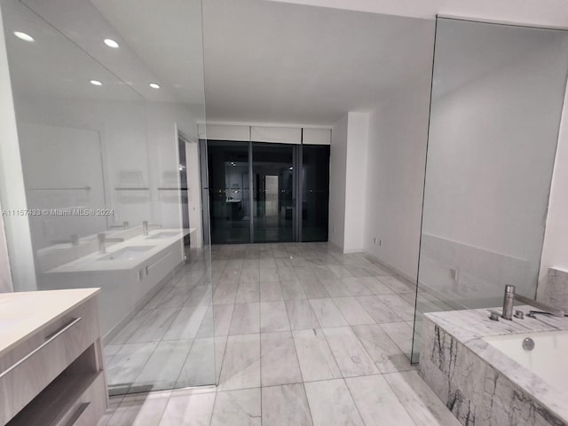 bathroom featuring vanity, tile flooring, and a bathing tub