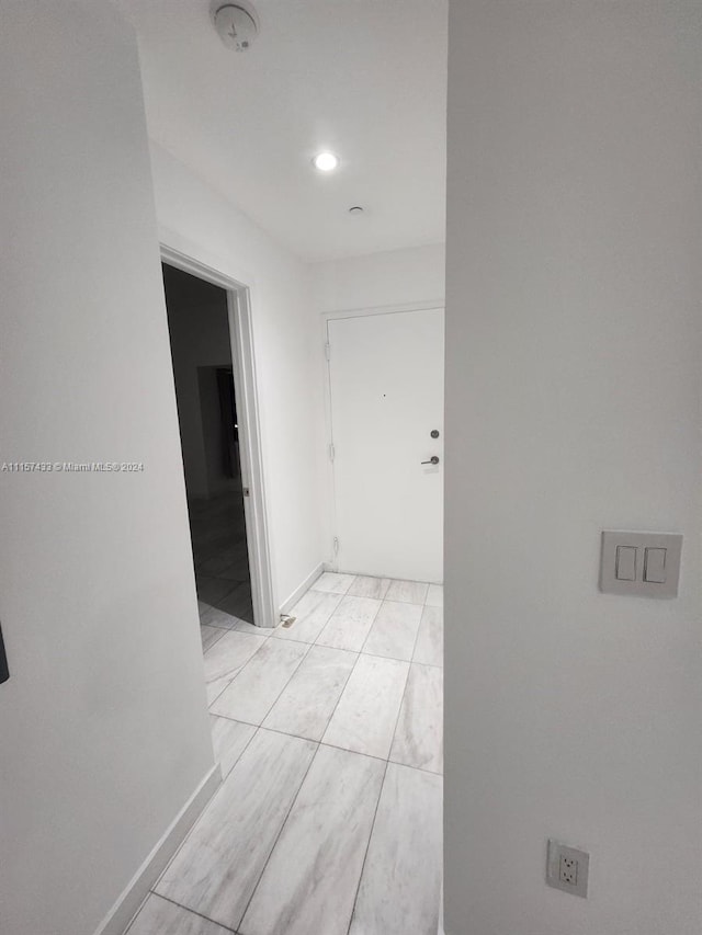 hallway with light tile floors