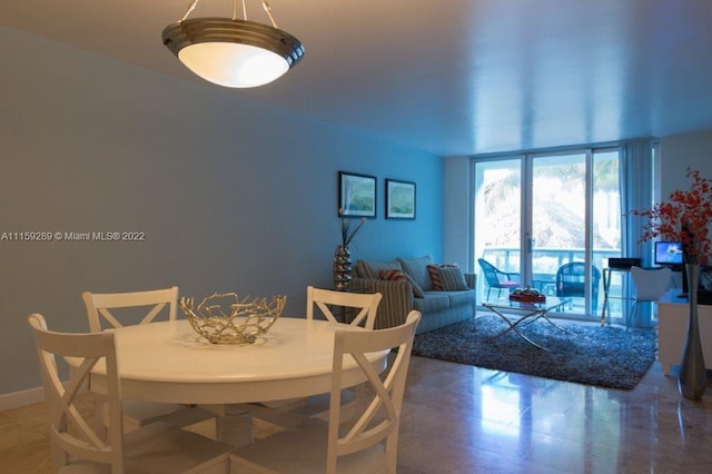 dining space with dark tile flooring