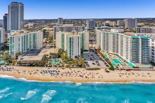 aerial view with a water view and a beach view