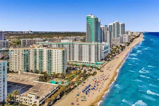 drone / aerial view featuring a water view and a view of the beach