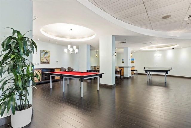 game room with a notable chandelier, pool table, dark hardwood / wood-style floors, and a raised ceiling