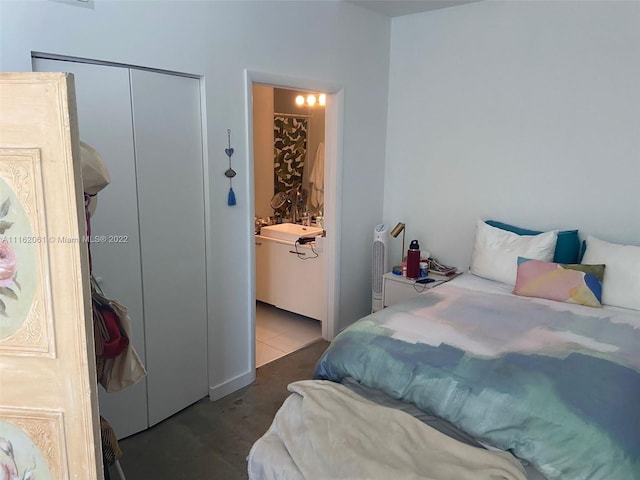 tiled bedroom with a closet and connected bathroom