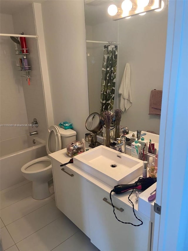 full bathroom with toilet, tile floors, shower / tub combo with curtain, and vanity with extensive cabinet space