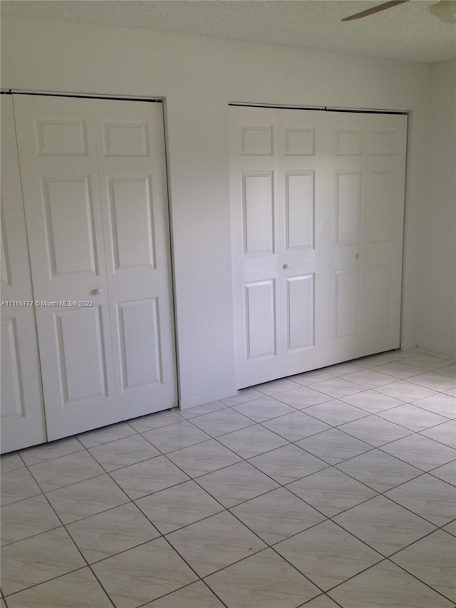 unfurnished bedroom featuring a textured ceiling and ceiling fan