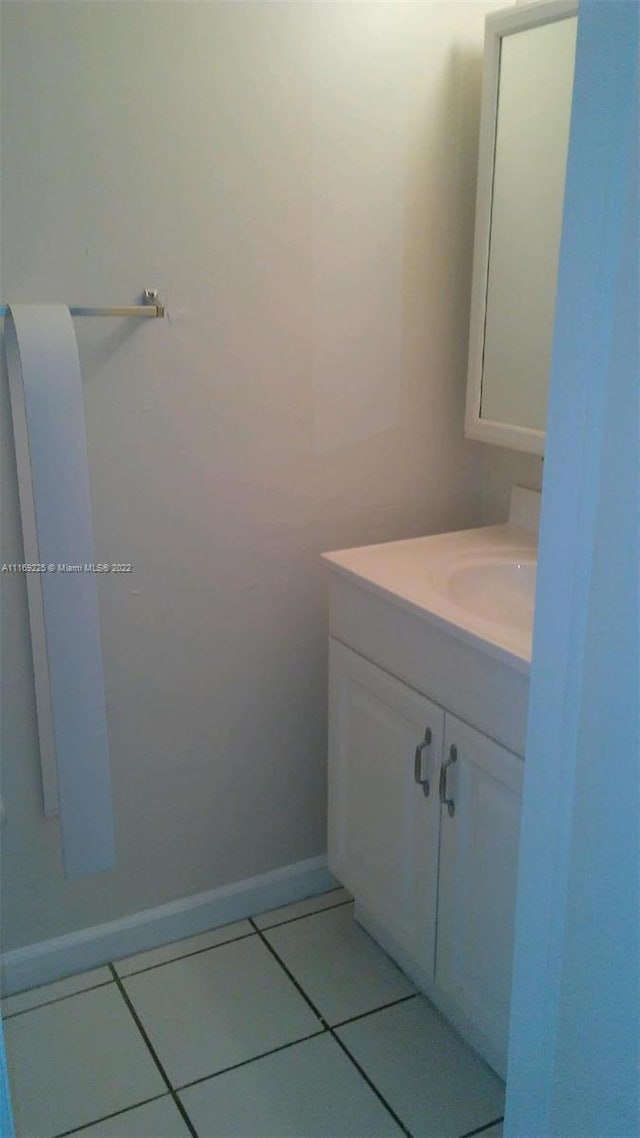 bathroom featuring tile patterned flooring and vanity