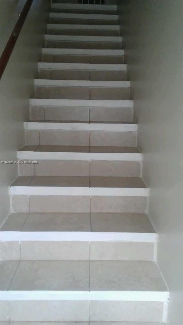 staircase featuring tile patterned floors