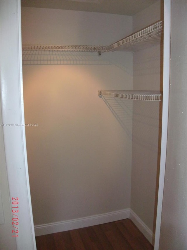 walk in closet featuring dark hardwood / wood-style flooring