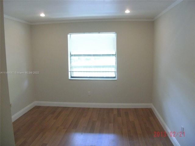 unfurnished room with crown molding and dark hardwood / wood-style flooring