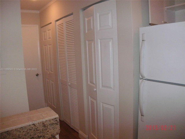 kitchen featuring crown molding and white fridge