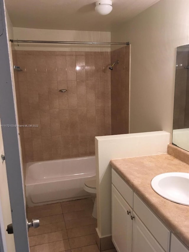 full bathroom featuring toilet, vanity, tile patterned floors, and tiled shower / bath combo