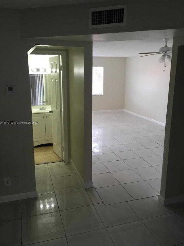 corridor featuring tile patterned flooring and sink