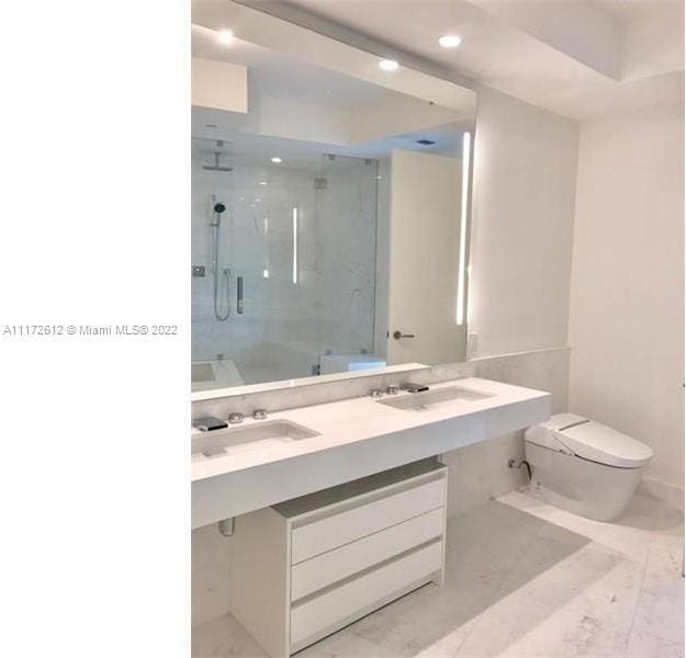 bathroom featuring toilet, tile flooring, and oversized vanity