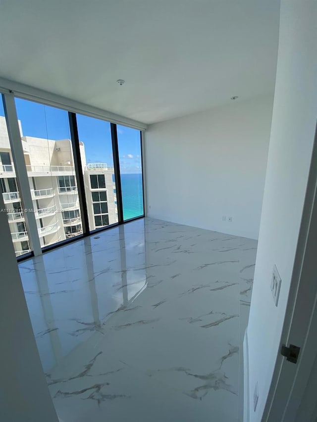 tiled empty room with a wall of windows