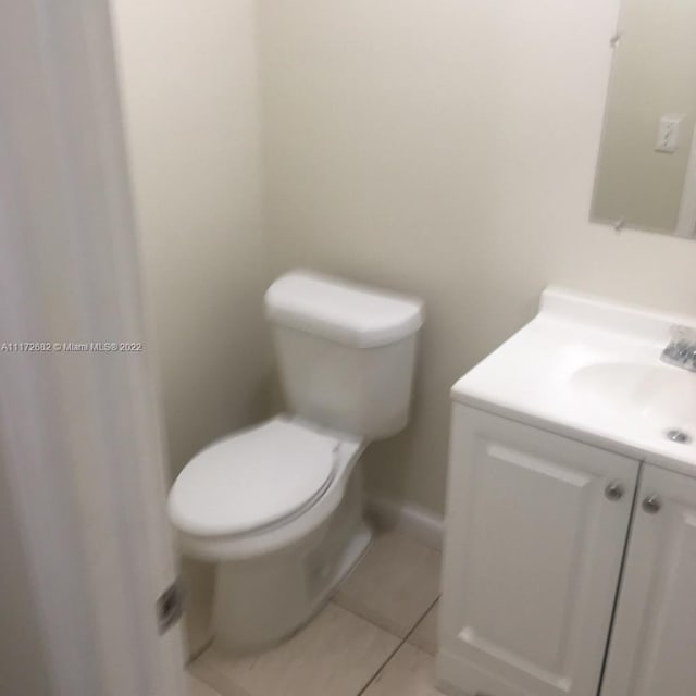 bathroom featuring tile patterned floors, vanity, and toilet