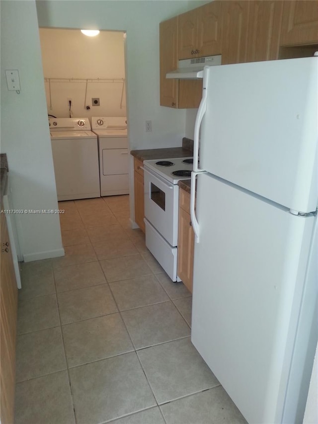 kitchen with white appliances, light brown cabinetry, light tile patterned floors, and separate washer and dryer