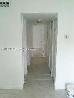 corridor featuring light tile patterned floors