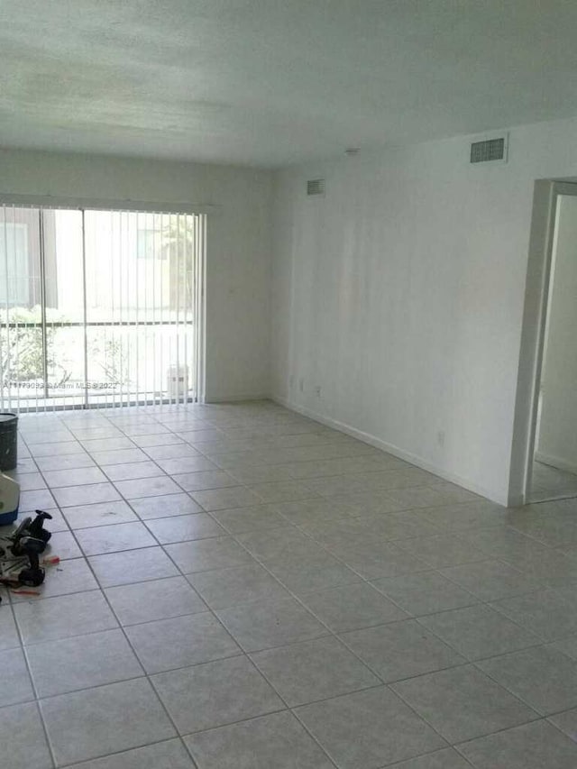 spare room with light tile patterned floors