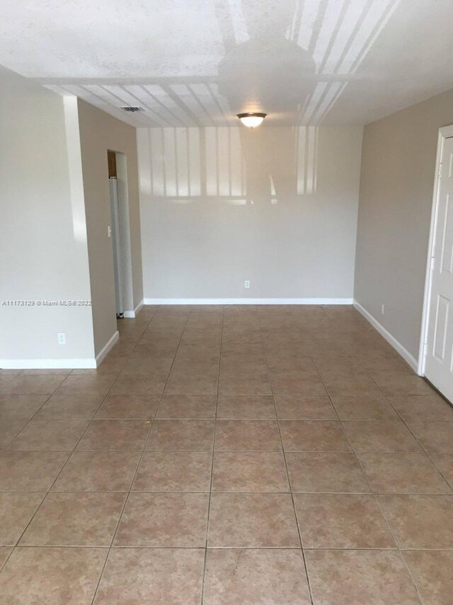 unfurnished room featuring tile patterned floors