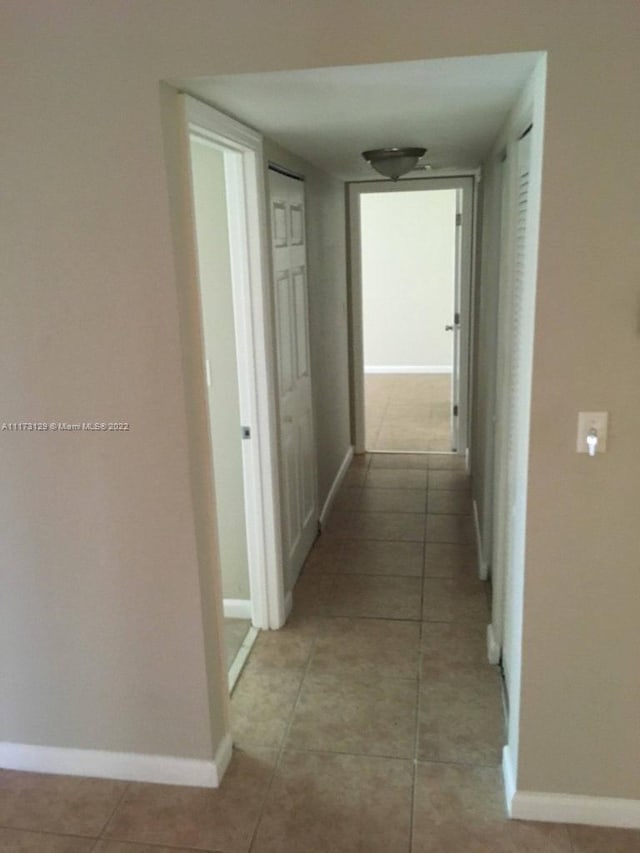 corridor featuring light tile patterned flooring